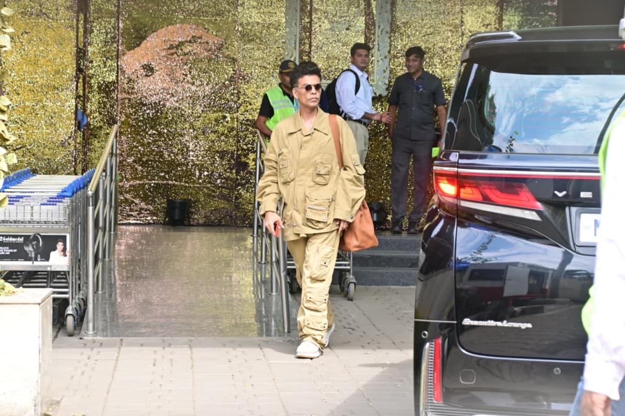 Karan Johar was also seen heading for a flight at the Kalina airport, sporting a khaki brown co-ord set paired with a tan tote bag.